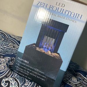 Led zen fountain with natural river stones .